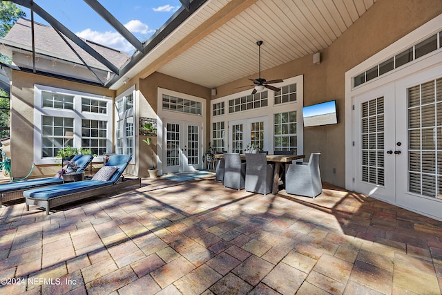 view of patio / terrace with french doors, ceiling fan, and glass enclosure