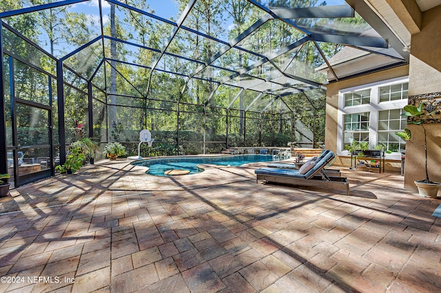 view of swimming pool featuring a patio area and glass enclosure