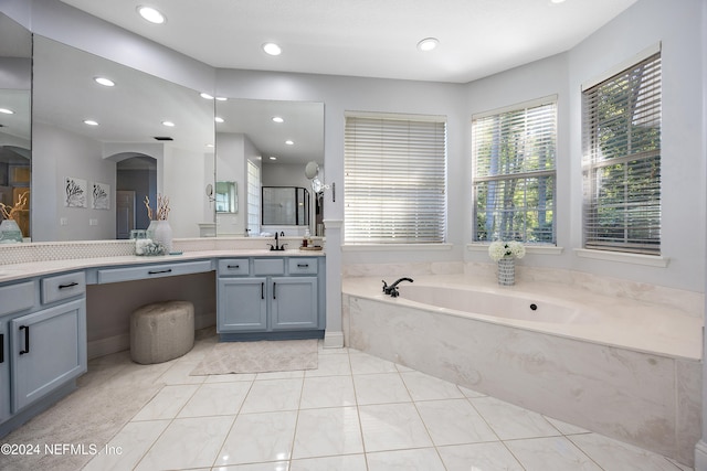 bathroom featuring tile patterned flooring, vanity, and separate shower and tub