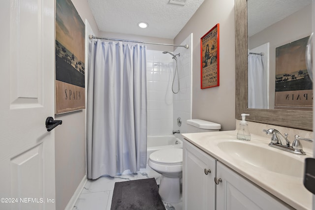 full bathroom featuring vanity, shower / bath combo, a textured ceiling, and toilet