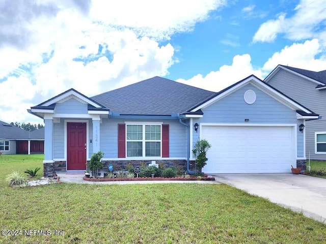 view of front of property with a garage and a front lawn