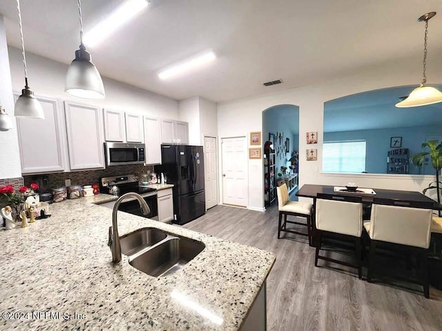 kitchen featuring white cabinetry, appliances with stainless steel finishes, sink, and backsplash