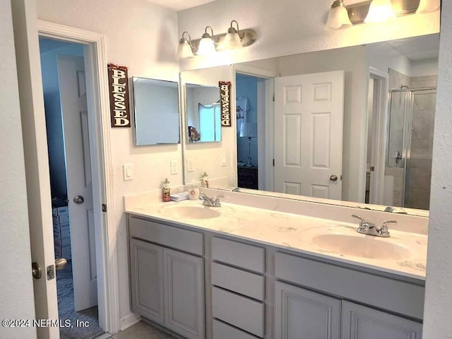 bathroom featuring vanity and an enclosed shower