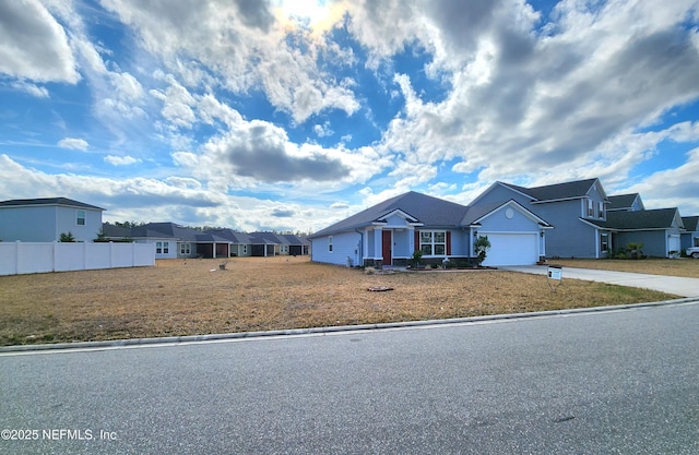 view of front of home with a garage and a front lawn