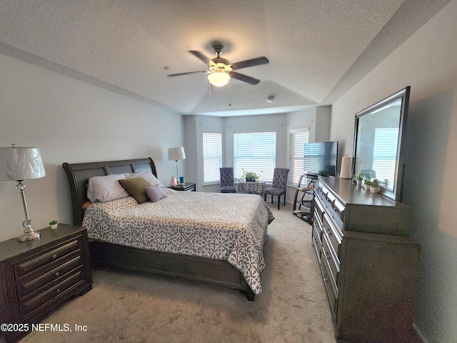 carpeted bedroom featuring ceiling fan and a textured ceiling