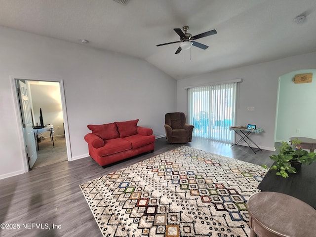 living room featuring lofted ceiling, dark wood-type flooring, and ceiling fan