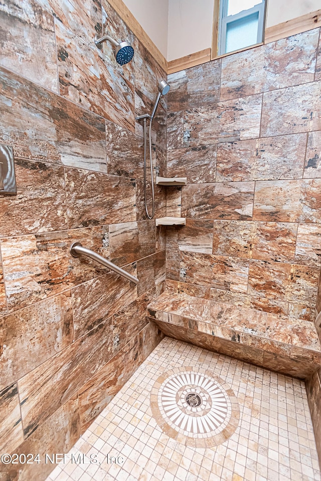 bathroom with a tile shower