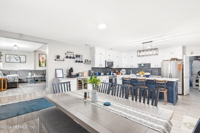 dining space with beverage cooler and light tile patterned flooring