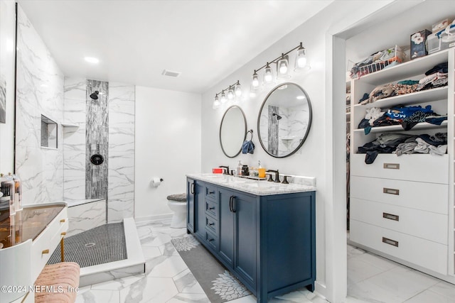 bathroom featuring vanity, toilet, and tiled shower