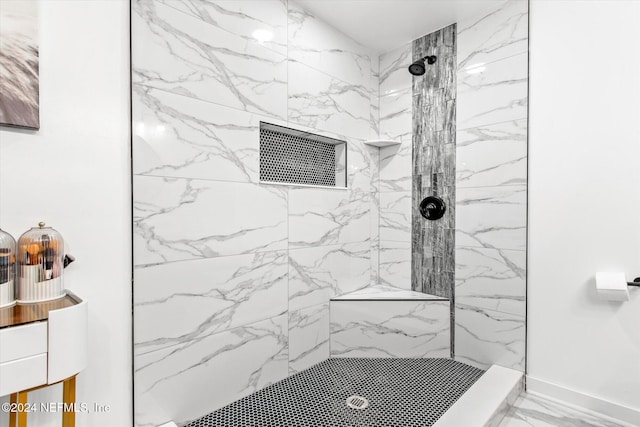 bathroom featuring tiled shower and vanity