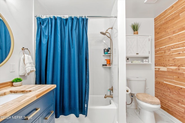 full bathroom with wood walls, vanity, shower / bath combo with shower curtain, and toilet