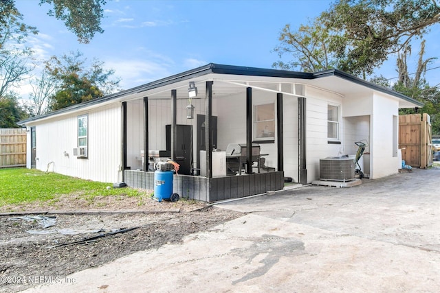 rear view of property with cooling unit