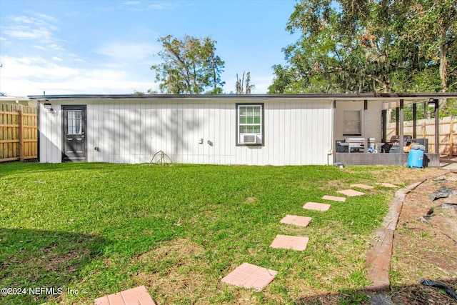 back of property featuring a yard