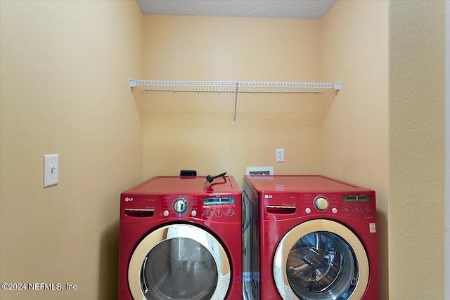 laundry room featuring washing machine and clothes dryer