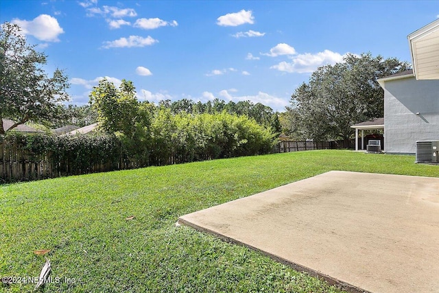 view of yard with central AC and a patio area