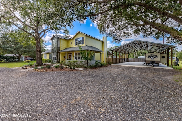 view of front of property featuring a carport and covered porch