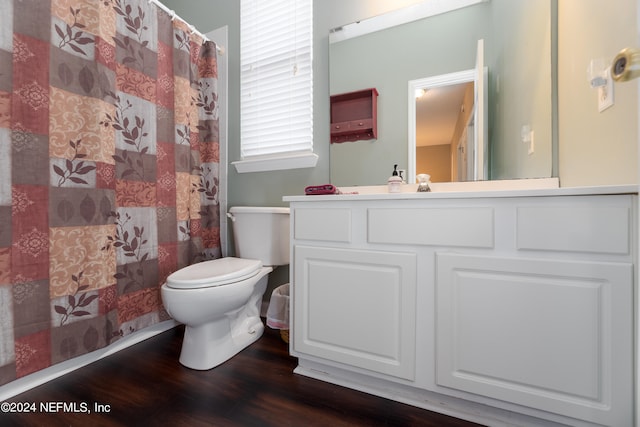 bathroom with curtained shower, vanity, toilet, and hardwood / wood-style flooring