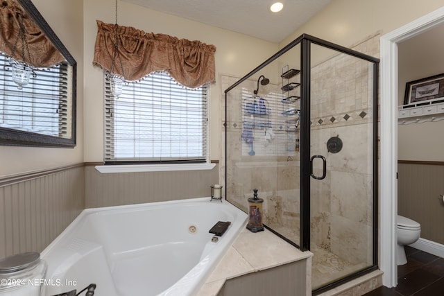 bathroom with toilet, independent shower and bath, and a textured ceiling