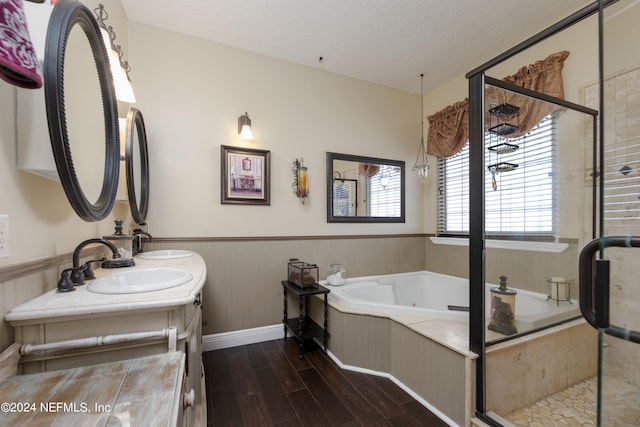 bathroom featuring separate shower and tub, vanity, wood-type flooring, and a textured ceiling