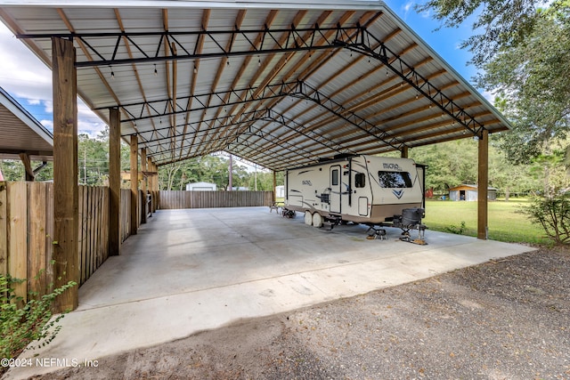 view of car parking featuring a yard and a carport