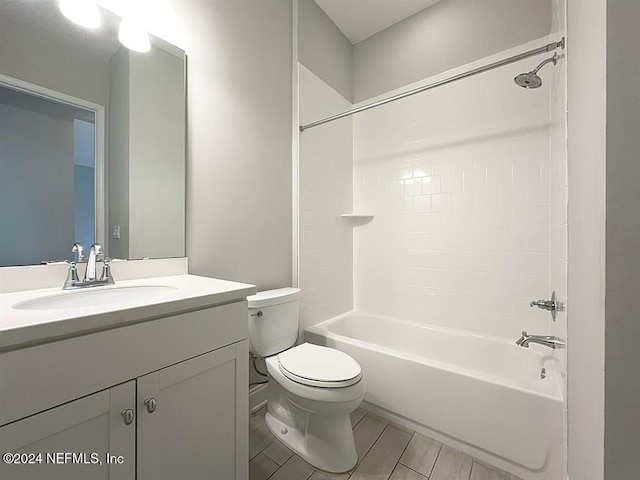 bathroom featuring toilet, shower / washtub combination, and vanity