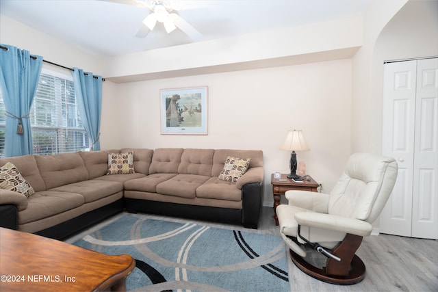 living room featuring ceiling fan and light hardwood / wood-style floors