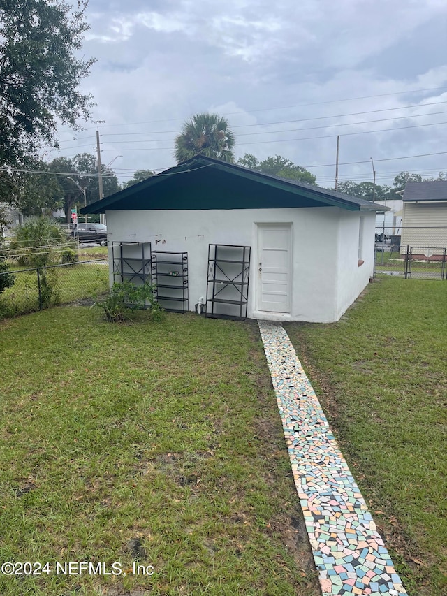 view of outbuilding featuring a yard