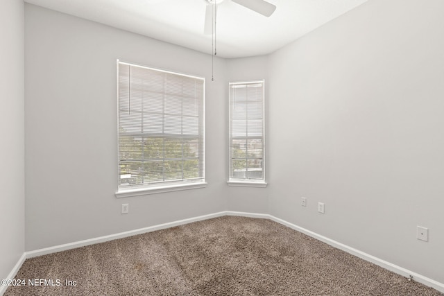 carpeted spare room with ceiling fan