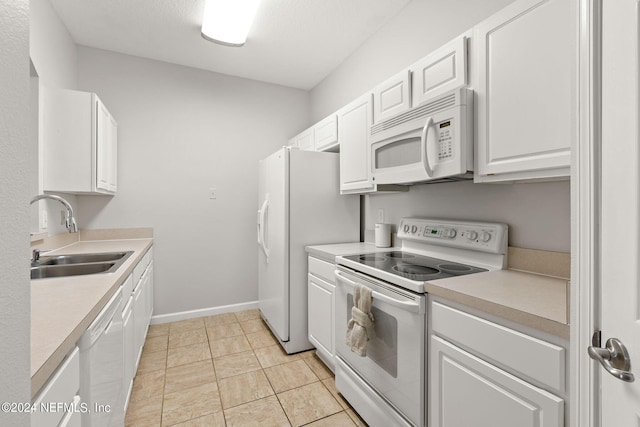 kitchen with white cabinets, sink, white appliances, and light tile patterned flooring