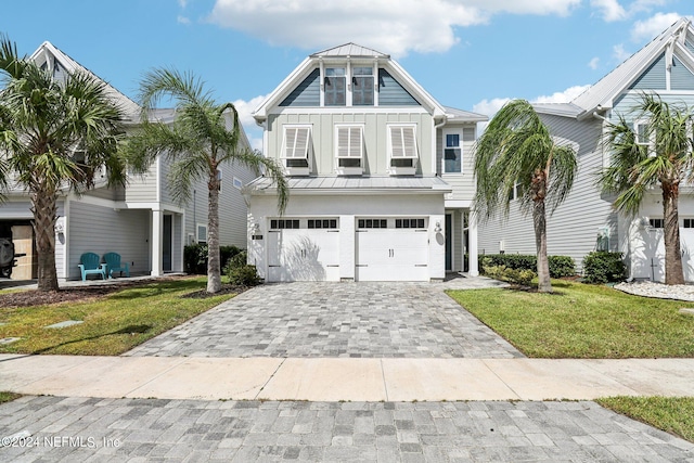 270 Clifton Bay Lp, Saint Johns, FL 32259 - view of front of property with board and batten siding, decorative driveway, cooling unit, an attached garage, and a front yard