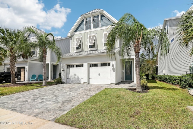 270 Clifton Bay Lp, Saint Johns, FL 32259 - view of front of home with an attached garage, a front lawn, board and batten siding, decorative driveway, and a standing seam roof