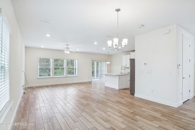 270 Clifton Bay Lp, Saint Johns, FL 32259 - unfurnished living room featuring recessed lighting, ceiling fan with notable chandelier, baseboards, and light wood-style floors