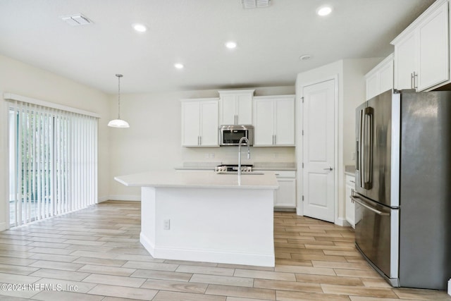 270 Clifton Bay Lp, Saint Johns, FL 32259 - kitchen with stainless steel appliances, baseboards, white cabinetry, light countertops, and light wood-type flooring