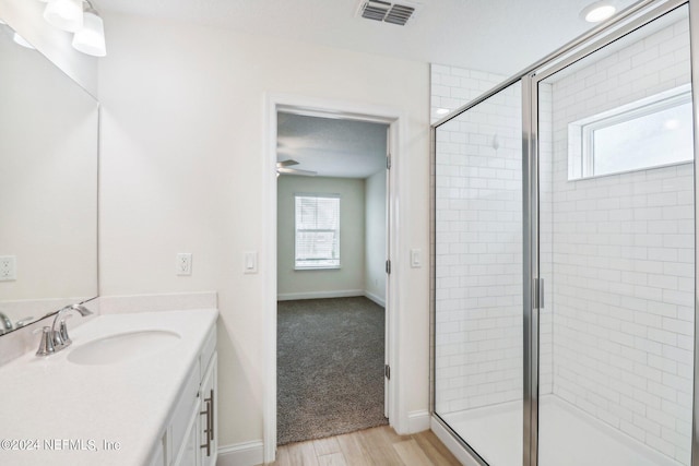 270 Clifton Bay Lp, Saint Johns, FL 32259 - bathroom with vanity, visible vents, wood finished floors, and a stall shower