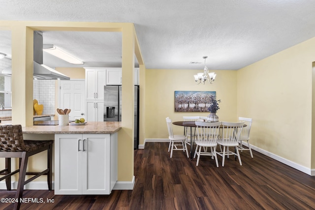 kitchen with white cabinetry, dark hardwood / wood-style flooring, pendant lighting, stainless steel refrigerator with ice dispenser, and light stone countertops