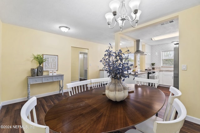 dining room featuring a textured ceiling, a notable chandelier, and dark hardwood / wood-style floors