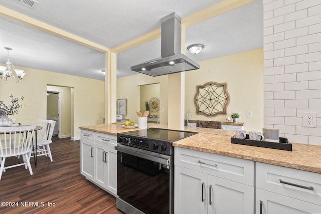 kitchen featuring white cabinets, hanging light fixtures, dark hardwood / wood-style floors, island exhaust hood, and stainless steel electric stove