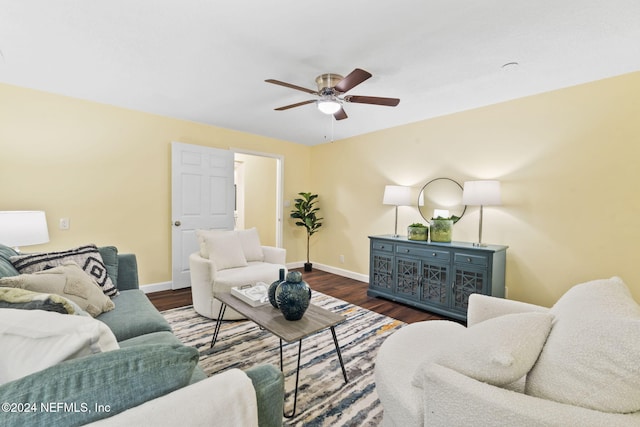 living room featuring dark hardwood / wood-style floors and ceiling fan