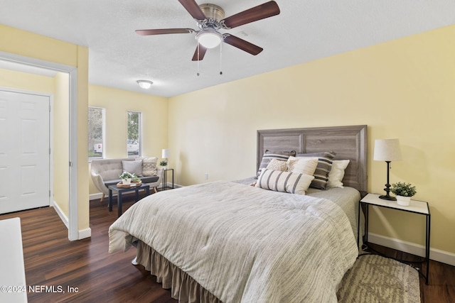 bedroom featuring ceiling fan, dark hardwood / wood-style floors, and a textured ceiling