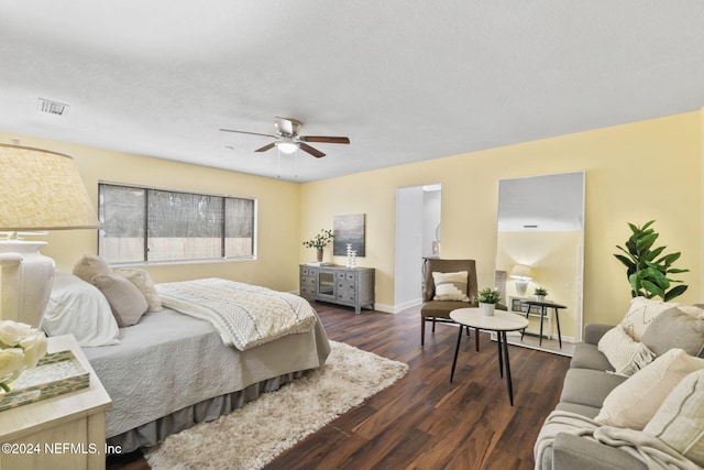 bedroom with dark hardwood / wood-style flooring, a textured ceiling, and ceiling fan