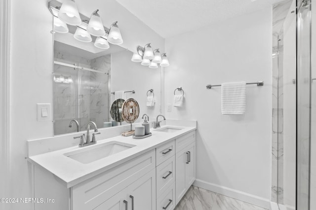 bathroom featuring vanity, a textured ceiling, and a shower with door