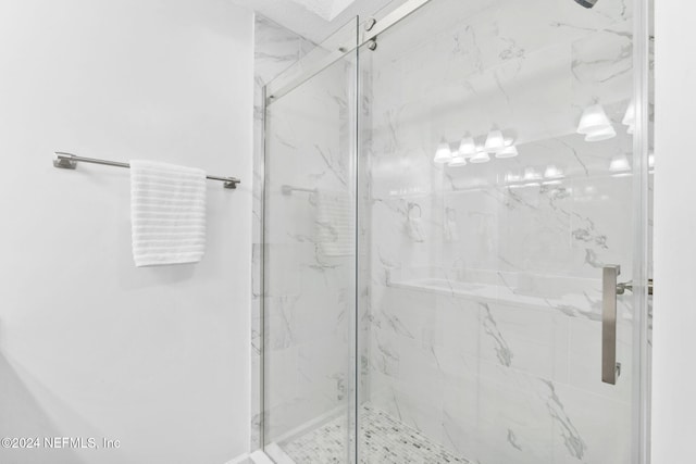 bathroom with a shower with shower door