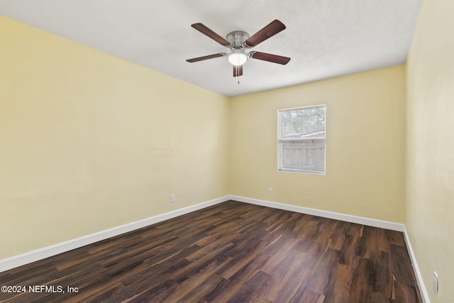 empty room with dark wood-type flooring and ceiling fan