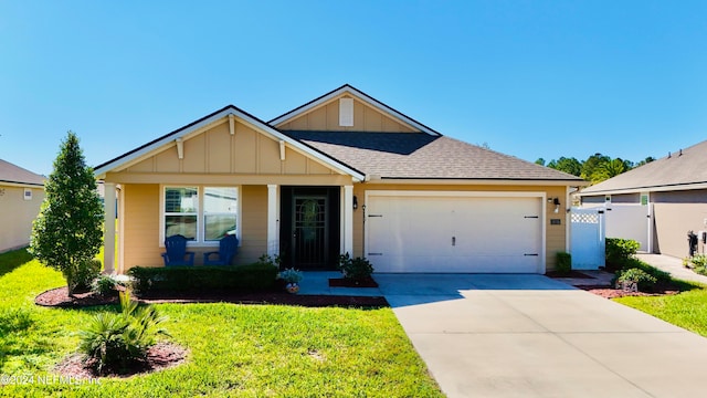 view of front of home with a garage and a front lawn