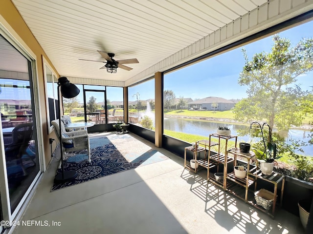 sunroom featuring a water view and ceiling fan