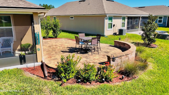 view of patio / terrace featuring cooling unit and a sunroom