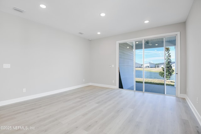 unfurnished room with light hardwood / wood-style floors