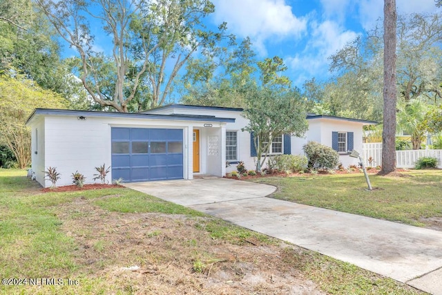 single story home with a garage and a front lawn