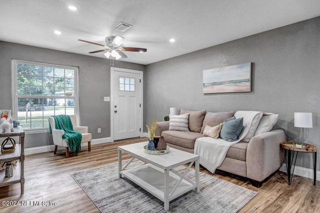 living room featuring ceiling fan and light hardwood / wood-style flooring