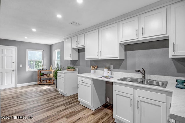 kitchen with white cabinetry, light hardwood / wood-style floors, and sink